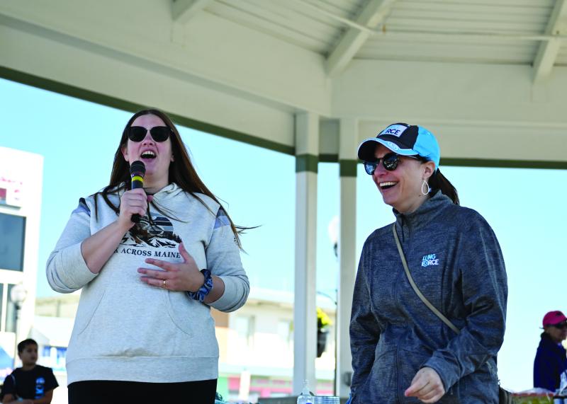 Kate Veiga and Cristina Kalesse, both event coordinators, get the crowd motivated and moving for the two-mile walk to support the American Lung Association.